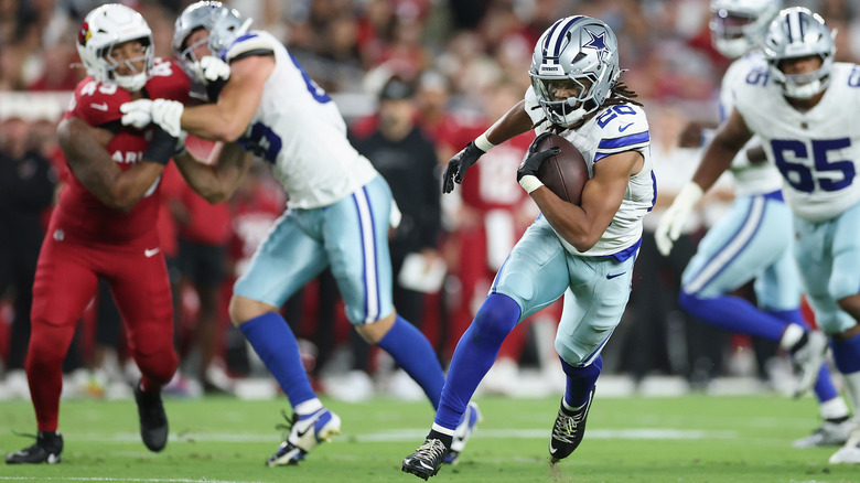 Dallas Cowboys football player running with football in his hand