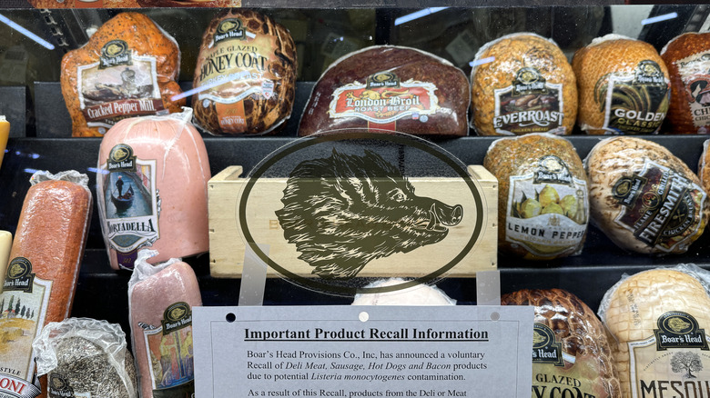 A Boar's Head logo on a glass front at a deli