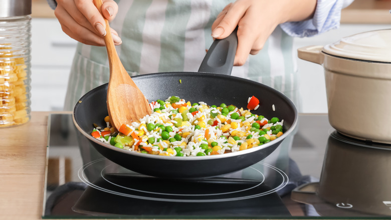 woman cooking with frying pan