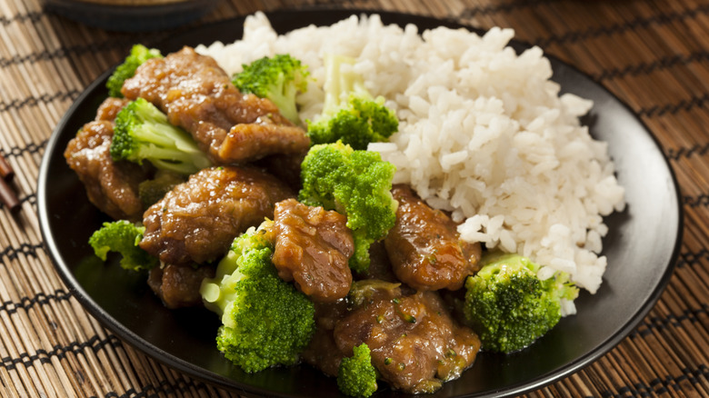 Beef and broccoli with rice on plate