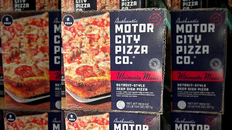 boxes of motor city co pizza on shelves at costco