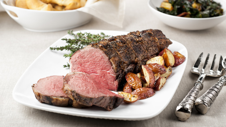 Beef tenderloin served on a plate with potatoes