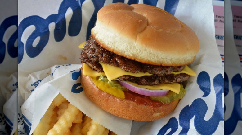 A Culver's ButterBurger in Culver's-branded paper, next to a bag of fries