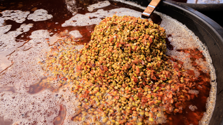 coffee beans being stirred in a fermenter