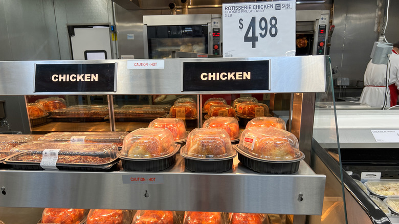 Boxes of Sam's Club rotisserie chicken sit under heat lamps.