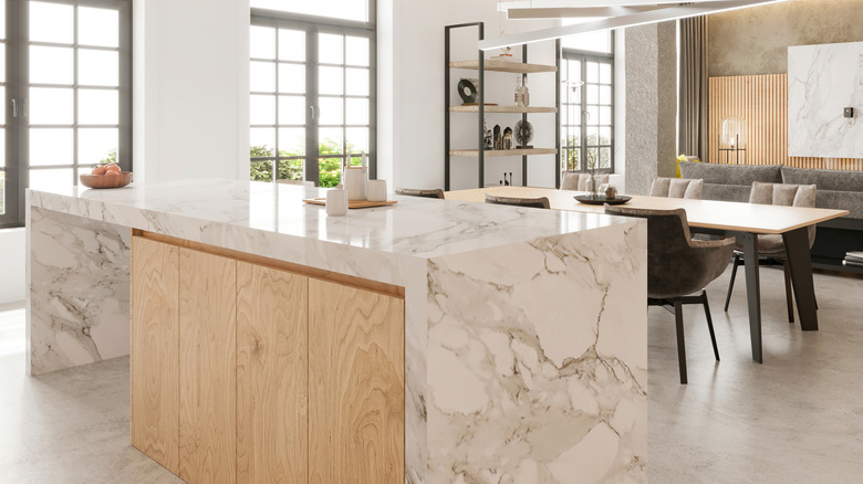 Kitchen island with white and grey marble waterfall countertop