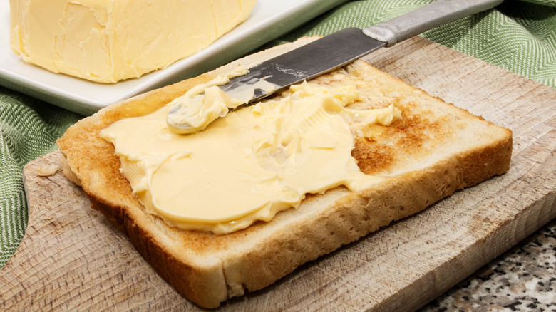 Irish butter spread on a piece of toast with a knife on top