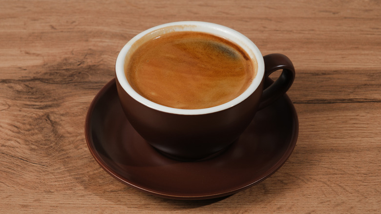 A cup of coffee on a wooden tabletop