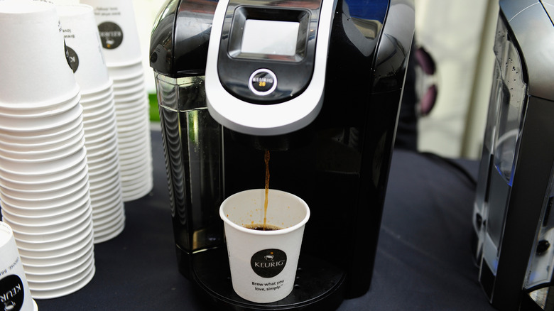 A Keurig coffee maker making coffee