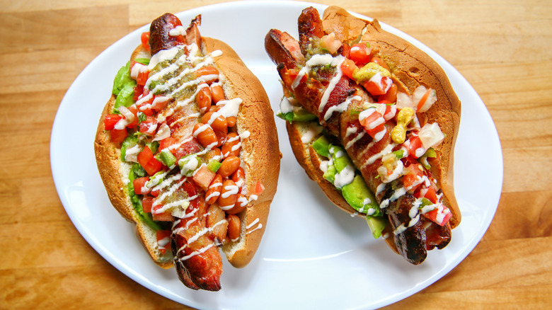 Two Sonoran-style hot dogs on a plate