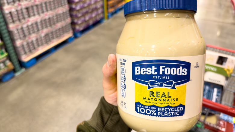 Costco member holding up a jar of Best Food's Mayonnaise