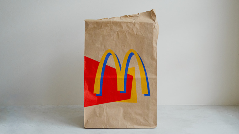 A vintage McDonald's brown paper takeout bag from the late 1990s or early 2000s on a plain light-colored background.