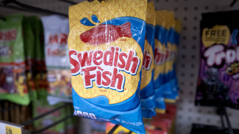 Close up of a package of Swedish Fish hanging in a store aisle.