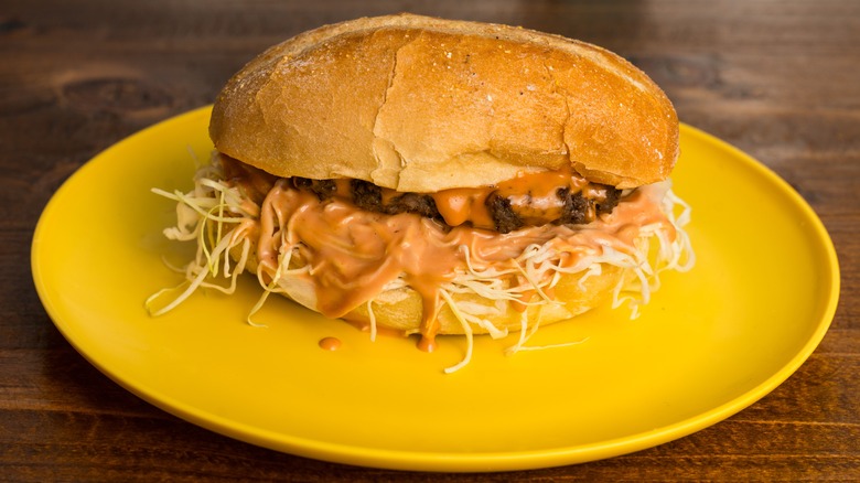 Chimichurri burger on yellow plate