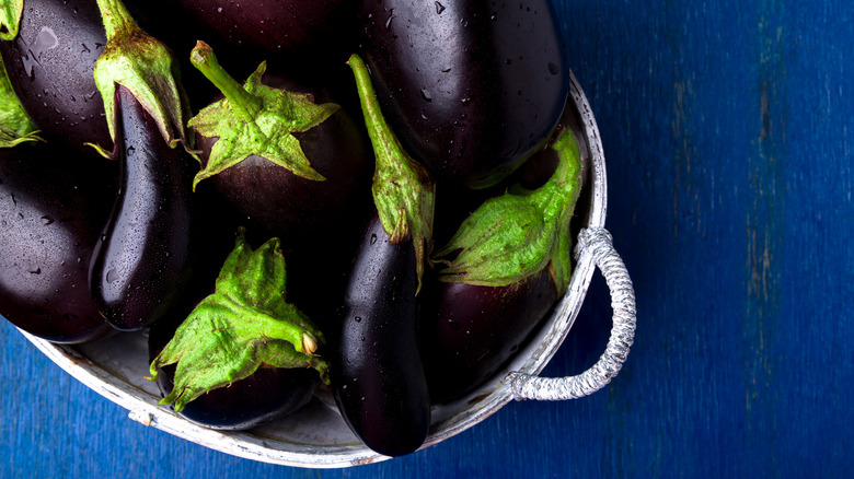 purple globe eggplants in bowl