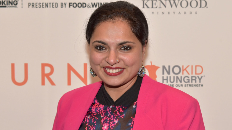 Close up of Maneet Chauhan smiling in pink jacket