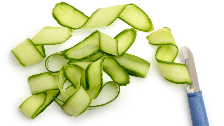 Cucumber ribbons and blue knife