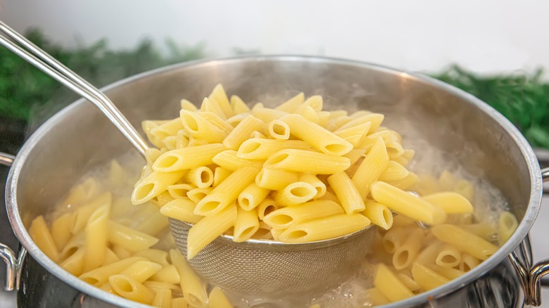 Penne pasta in a pot cooking in boiling water