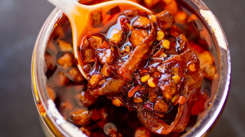 spoon of chili crisp over jar