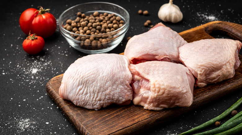 raw chicken thighs on a cutting board