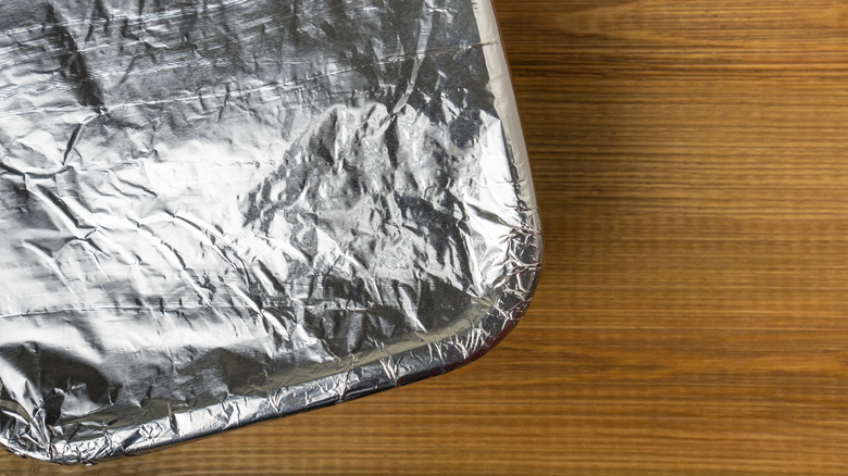 Pan wrapped in foil on wood counter