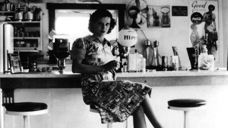 Woman sitting at lunch counter