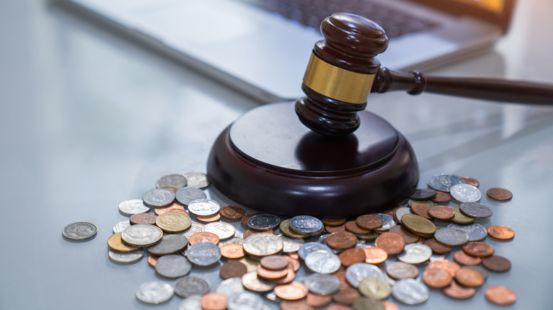 Judge's gavel and coins on a table