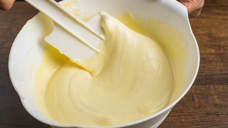 Folding cake batter with spatula in bowl