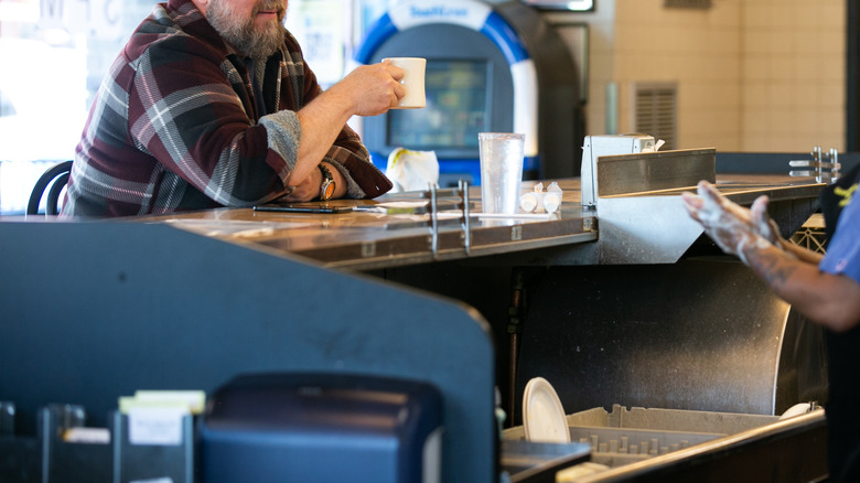 customer sitting at counter at Waffle House
