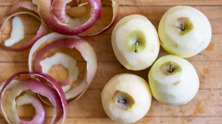 Whole peeled apples and apple skin