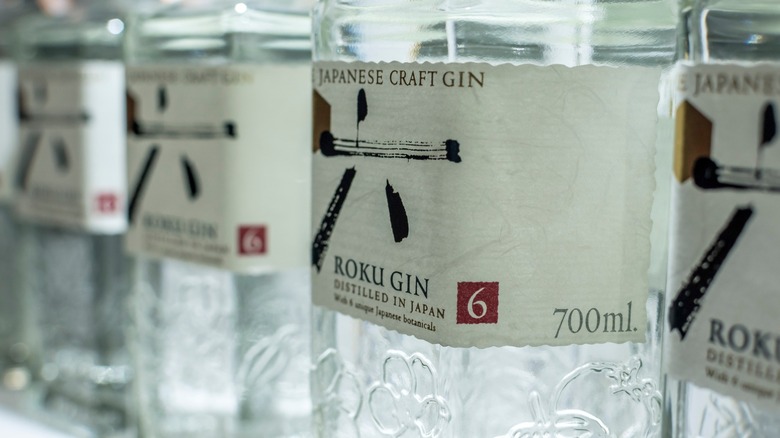 Several bottles of Roku Gin, a Japanese gin brand, in a row on a shelf