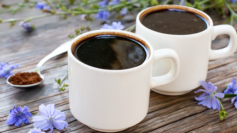 two coffee cups with flowers and spoon