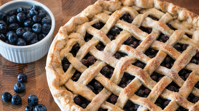 Blueberry pie and cup of blueberries