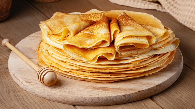 stack of crepes on wood platter