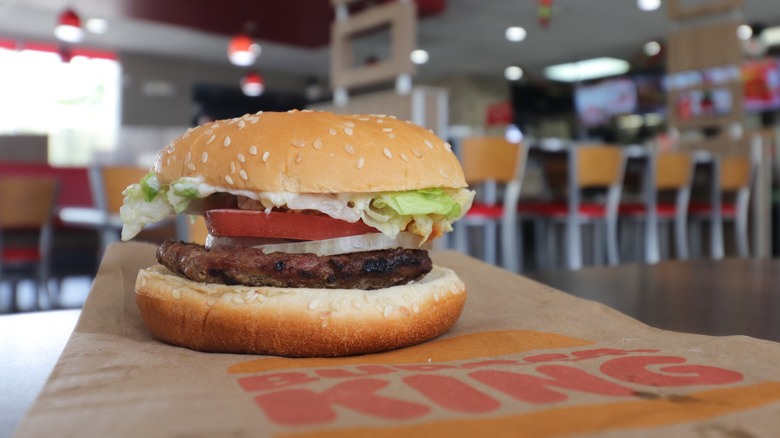 Whopper on a table inside a Burger King