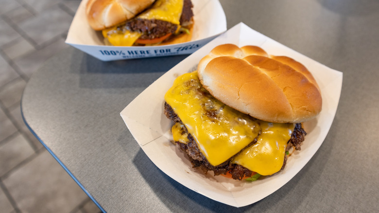 Two Culver's Butterburgers with cheese in trays on table