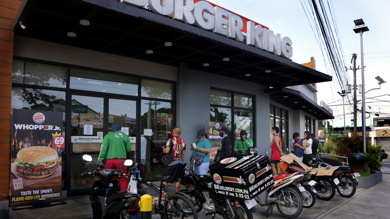 People lined up outside a Burger King during Covid protocols.
