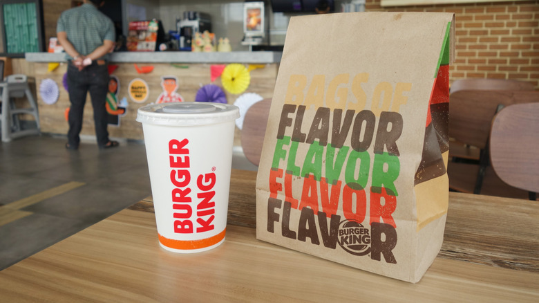 Burger King bag an drink on table