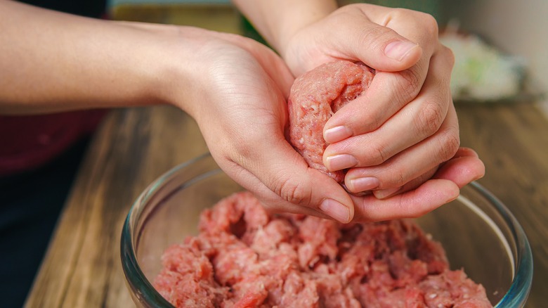 Hands shaping ground beef