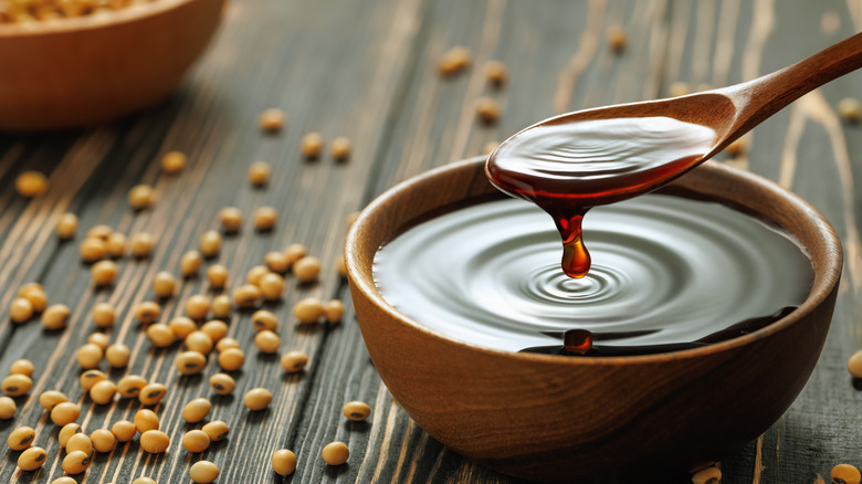 Dipping spoon in bowl of soy sauce