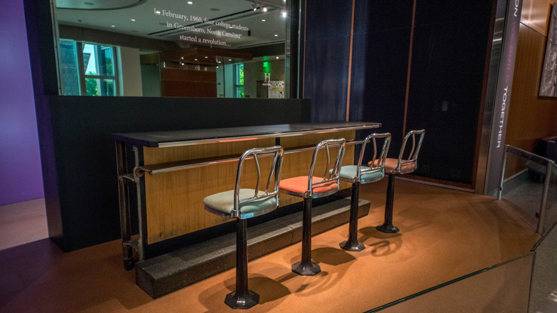 A four-seat section of the Greensboro, NC Woolworth lunch counter on museum display