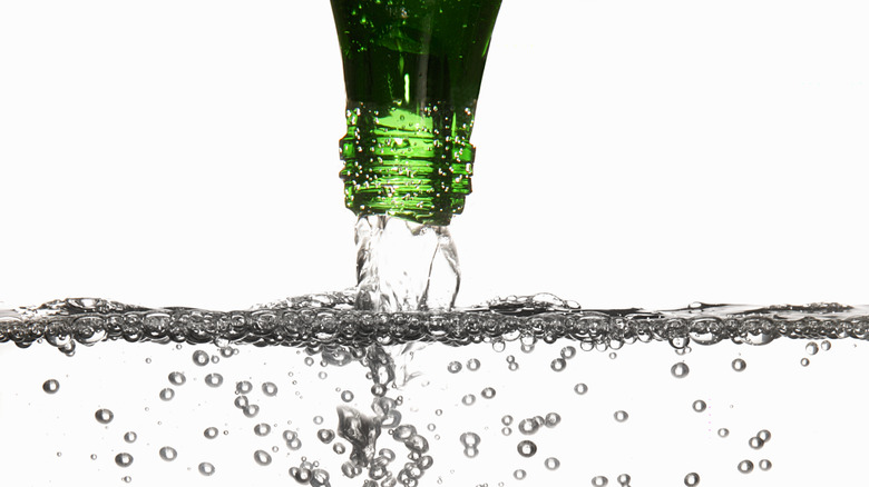 Bottle pouring out carbonated water