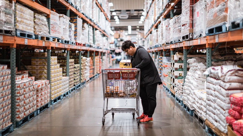 Shopper with grocery cart in Costco aisle