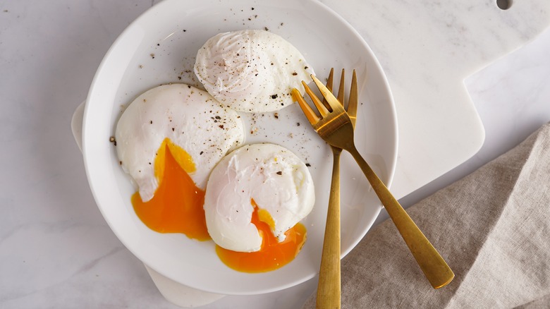 Three plated poached eggs