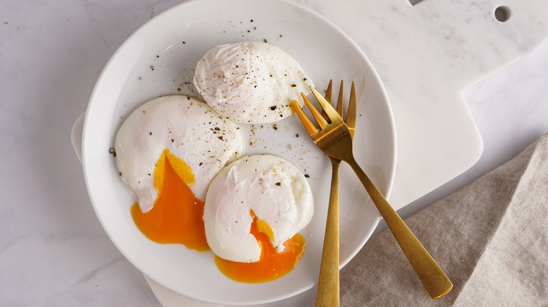 Freshly poached eggs on plate 