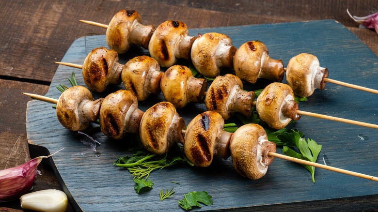 grilled mushrooms on wood skewers