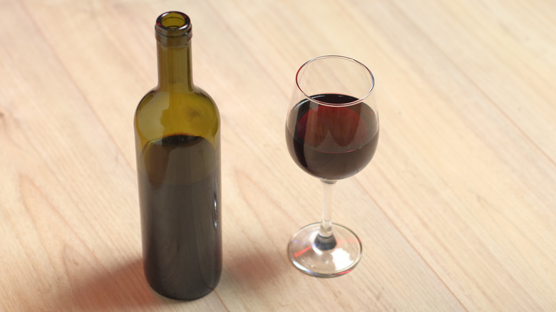 Wine glass with open bottle