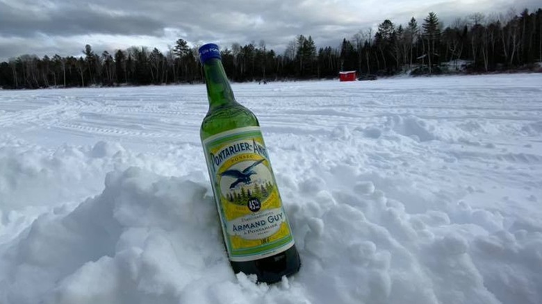 Bottle of Pontarlier-Anis in snowy field