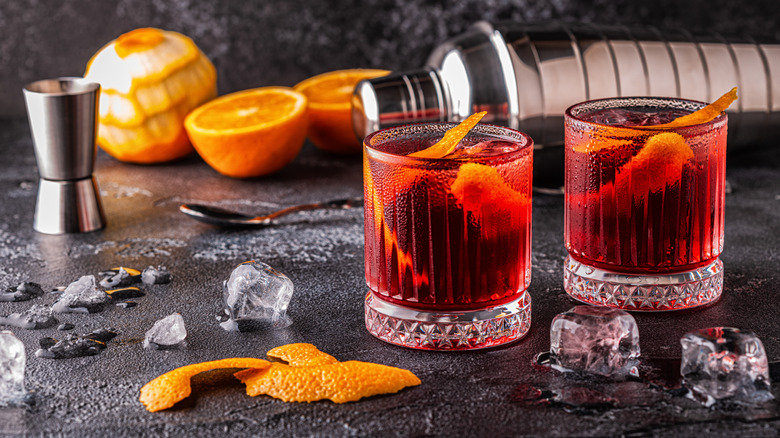 Two negronis on counter with ingredients