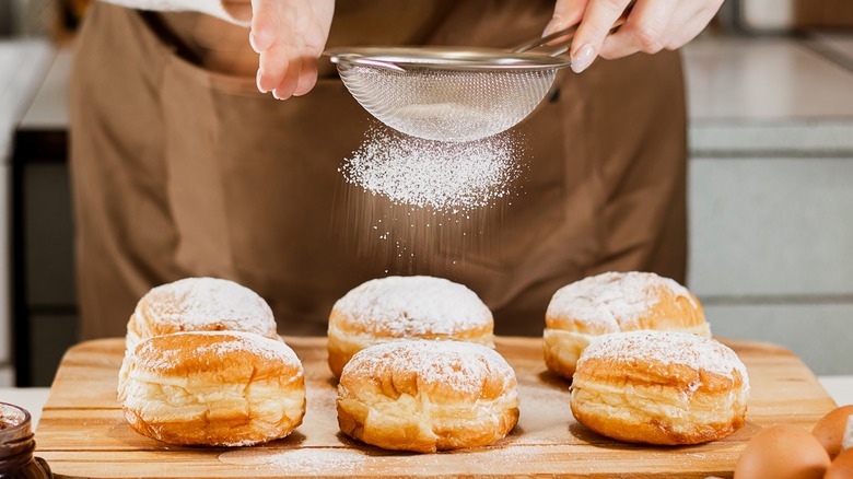 powdered sugar sifted onto donuts